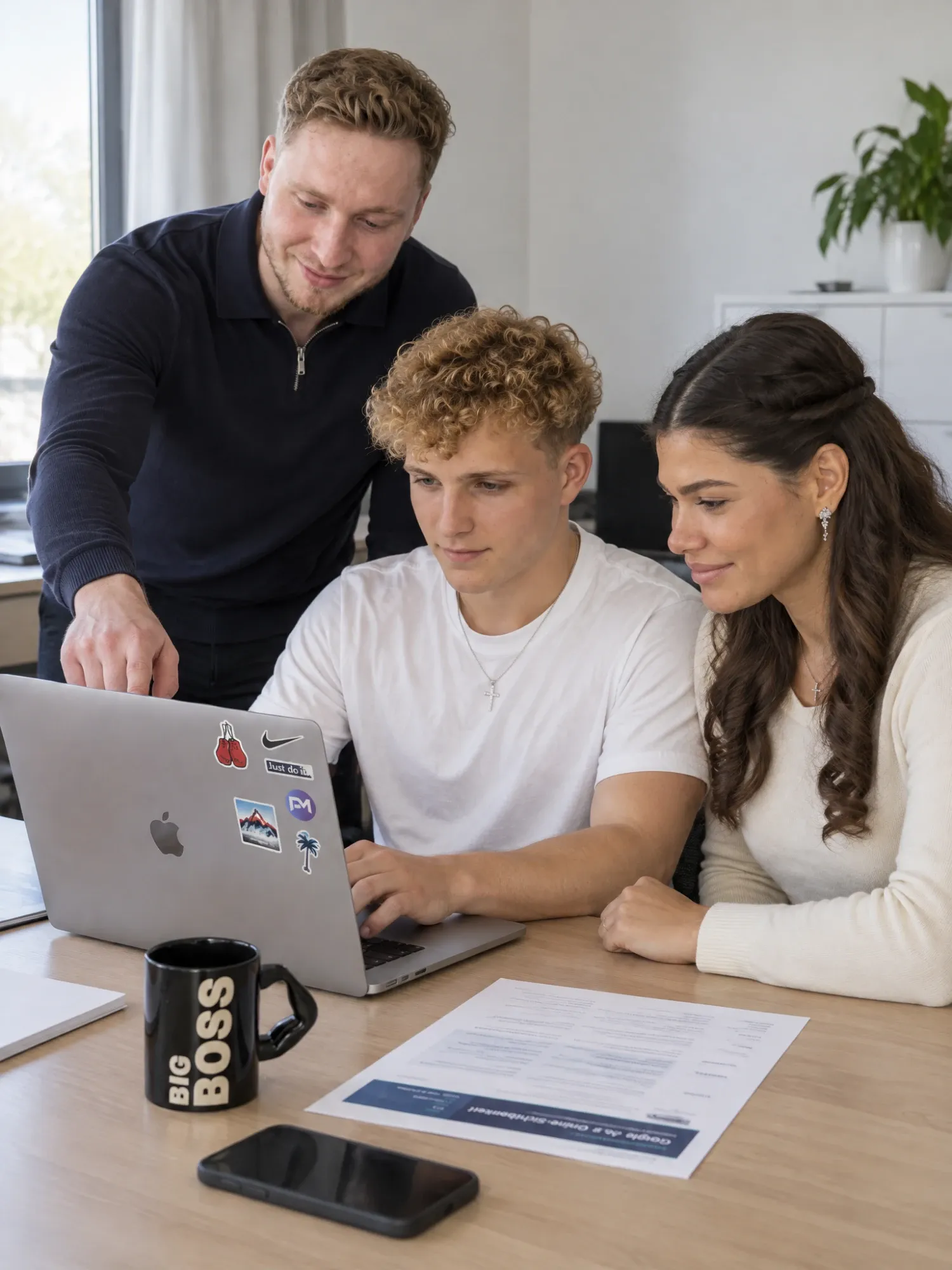Paulius bespricht mit Tomas und Steffany ein Projekt am Laptop
